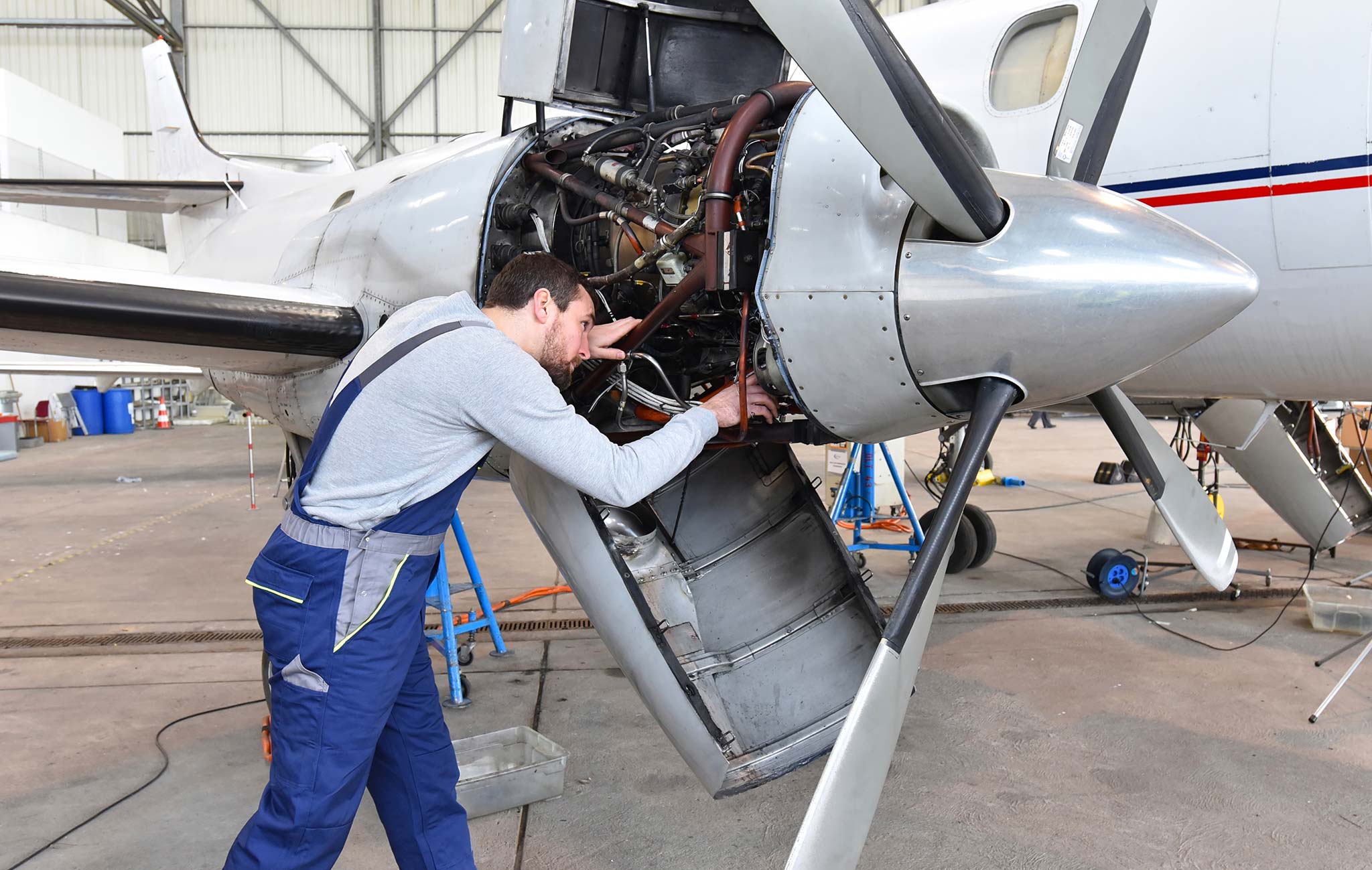 Istock 1343515589 Aircraft Mechanic Repairs An Aircraft Engine 