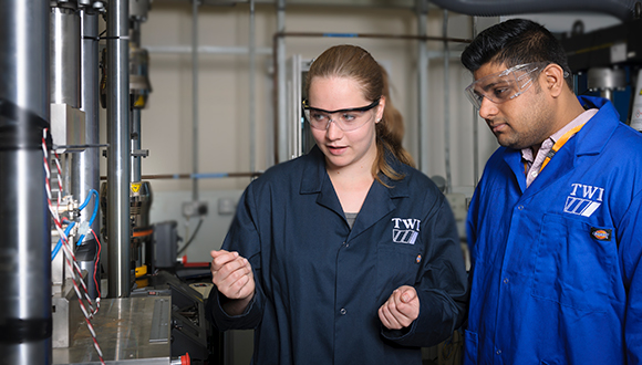 From left, Jessica Taylor, showing fellow NSIRC student Vishal Vats around TWI structural integrity testing facilities in Cambridge. Photo: TWI Ltd